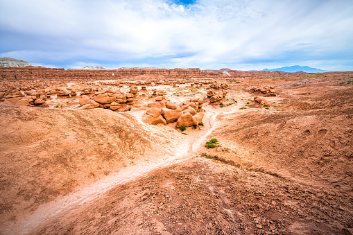 Hiking trail path at Goblin valley state park, Utah with nature desert valley landscape and hoodoo sandstone rock formations showing canyon erosion