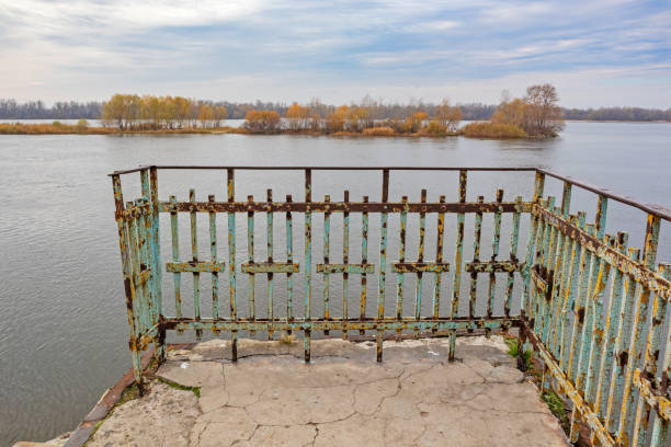Old embankment on the banks of the Dnieper River in Kremenchuk City. Rusty metal railing stock photo