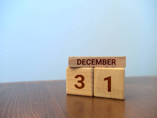 Wooden bricks calendar with engraved date "December 31" standing on a desk Wooden bricks calendar with engraved date "December 31" standing on a desk december 31 stock pictures, royalty-free photos & images