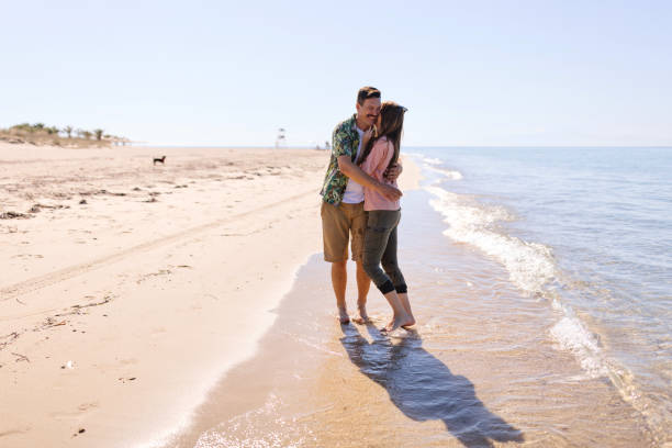 istock A couple is walking on the beach during a sunny spring day 1445001562