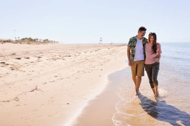 istock A couple is walking on the beach during a sunny spring day 1445001625