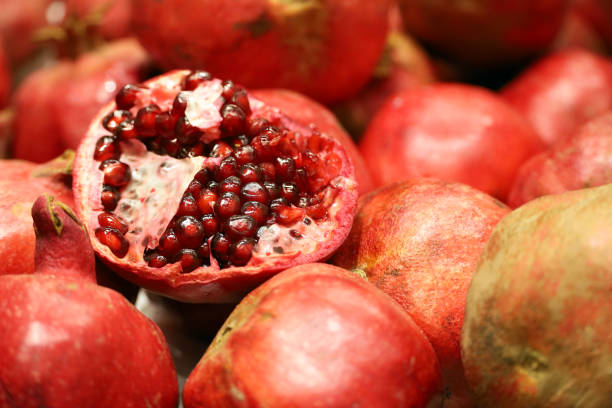 istock Red juicy pomegranates with seeds close up 1445002755