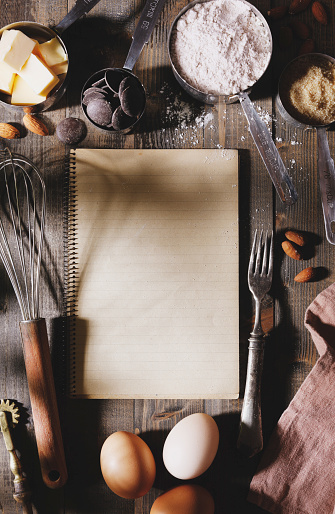 Rustic cookbook and kitchen utensils with copy space