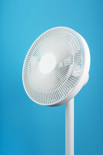 istock A high-tech white electric fan with a modern design for cooling the room on a blue background 1445004645