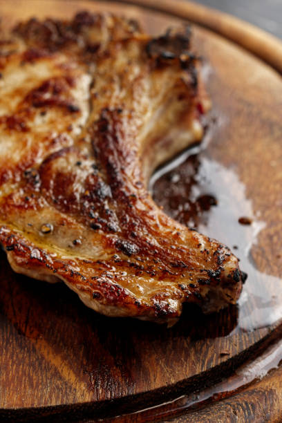 istock Crispy fried pork chop on wooden cutting board. 1445005262