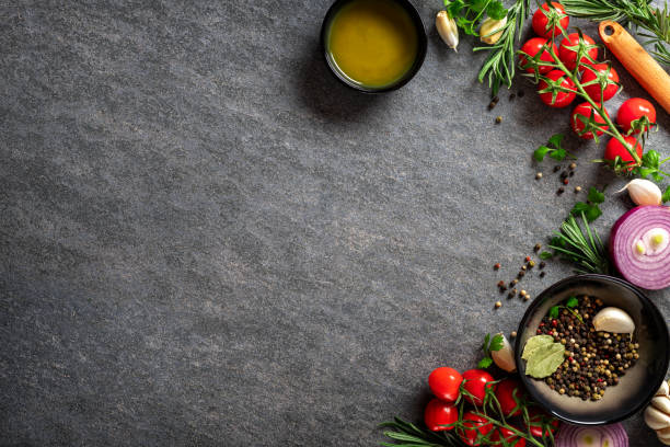 istock Vegetables and spices on the kitchen table with copy space top view. Dark cooking food background. Culinary concept 1445005651