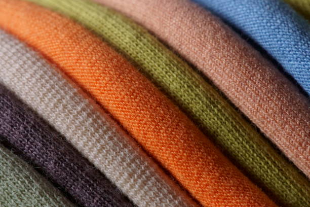 Macro photography with multicolored textile used to make t-shirts; texture background; textile industry background.