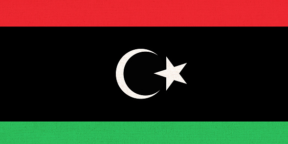 Flag of Libya. Libyan flag on fabric surface. Fabric texture. State of Libya. Libyan state symbol. African country. flag of Libya with red black and green ribbons