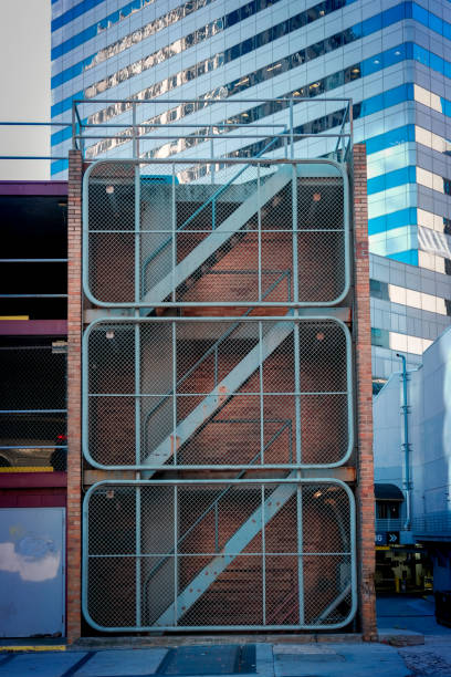Fenced multi level stairway to parking garage in uptown.