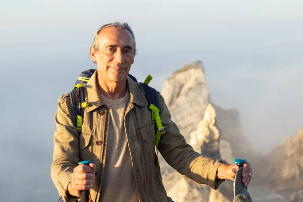 istock Portrait of handsome elderly man at mountain peak 1445010088
