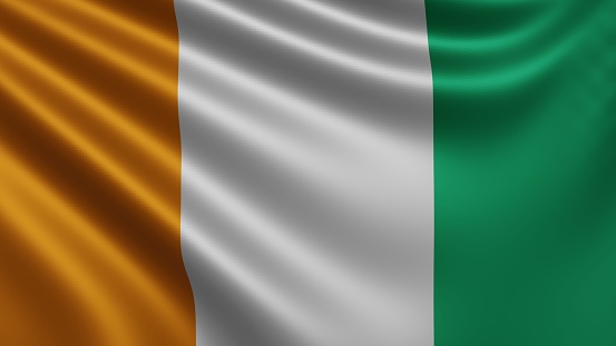 Render of the Ivory Coast flag flutters in the wind close-up, the national flag of Cote d'Ivoire Flutters in 4k resolution, close-up, colors: RGB. High quality 3d illustration