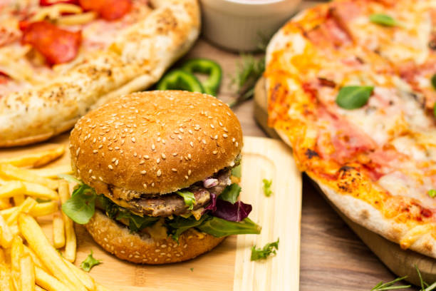 istock Pizza and hamburger on wooden background 1445013645
