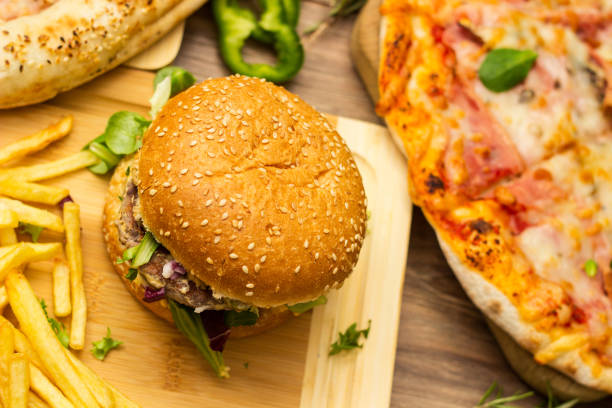 istock Pizza and hamburger on wooden background 1445013707