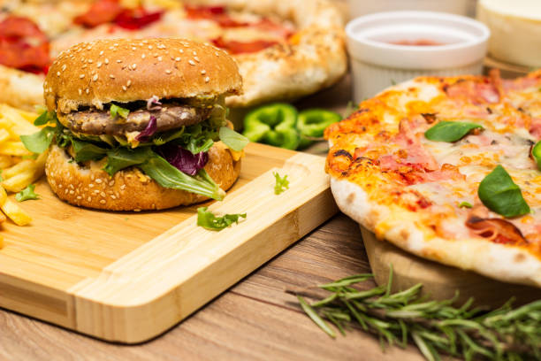 istock Pizza and hamburger on wooden background 1445013718