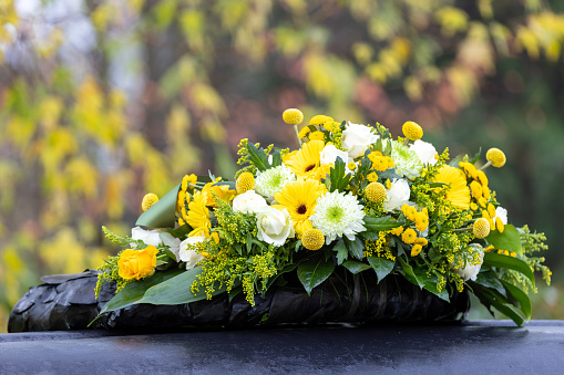 Funeral wreath with yellow and white flowers