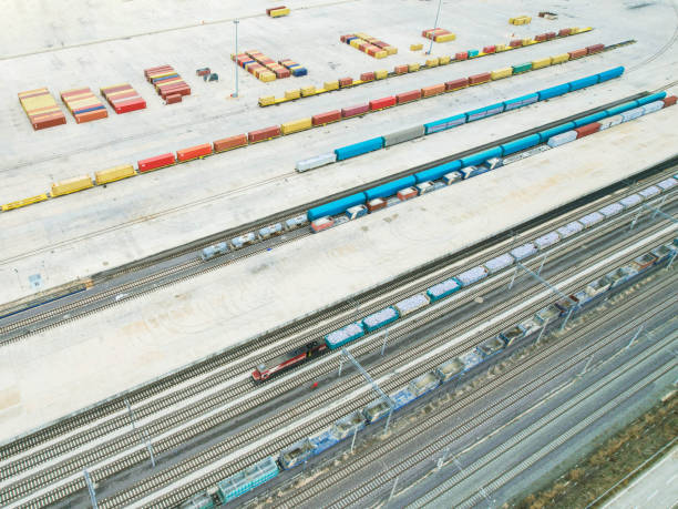 istock freight train carrying freight container, with rows of containers in the background, drone view 1445019211