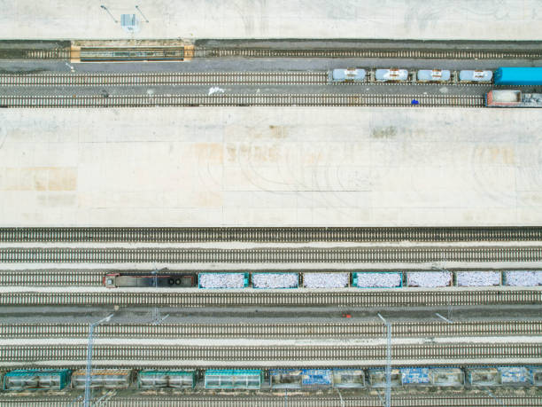 istock freight train carrying freight container, with rows of containers in the background, drone view 1445019331