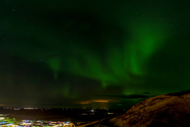 istock Aurora borealis over a town in Iceland. 1445020697