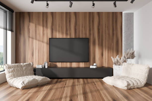 istock Stylish chill interior with armchairs, drawer and tv screen, panoramic window 1445021697