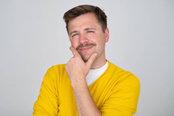 istock Thoughtful caucasian young man touch chin with finger thinking 1445022740