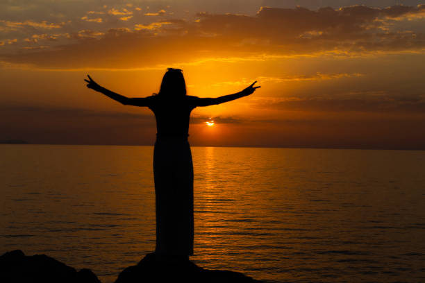 istock A female tourist making a victory sign at sunset. 1445023028