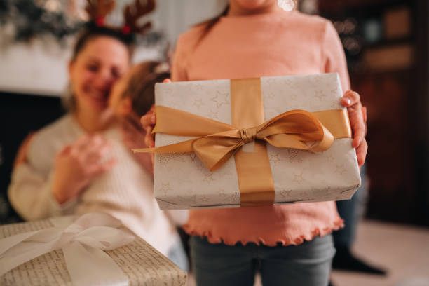 istock Young girl cannot wait to open her Christmas present 1445023845
