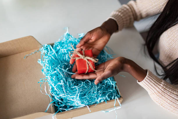 istock Young African woman receiving gift box 1445023891