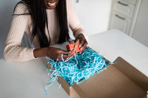 istock Young African woman receiving gift box 1445023893