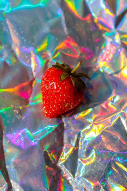Defocus close-up one ripe red strawberry on modern hologram background. Fruits and berries. Harvest crop concept. Organic. Trendy gradient. Shiny foil. Out of focus
