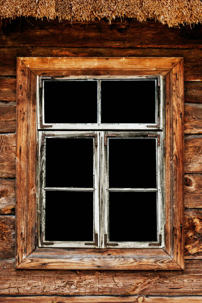 istock Wooden rustic window in small cottage house. Empty copy space black inside window. Handmade brown frame. Wooden window background. 1445027419