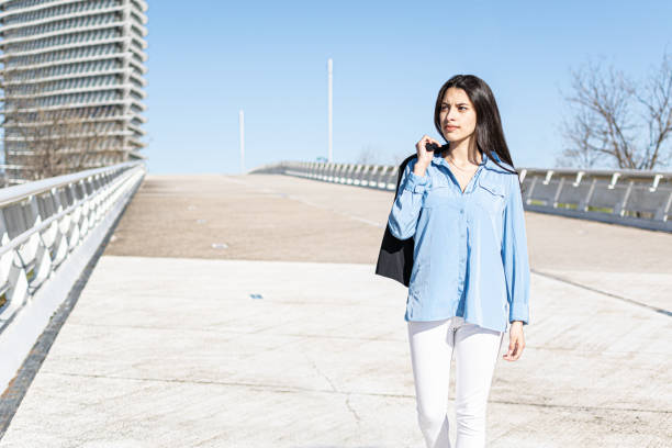 young woman in black jacket walking