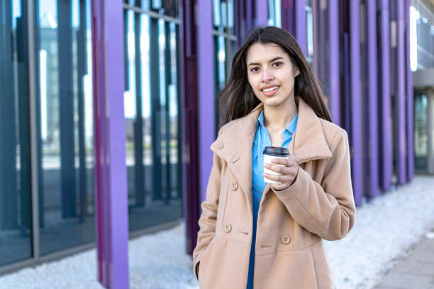 istock Young businesswoman with coffee in an office environment. Copy space 1445027785