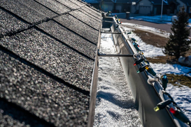 istock Ice and snow building up inside a rooftop gutter system on a residential house 1445028636