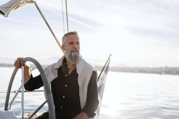 istock Mature man sailing his yacht on a sunny day 1445031267
