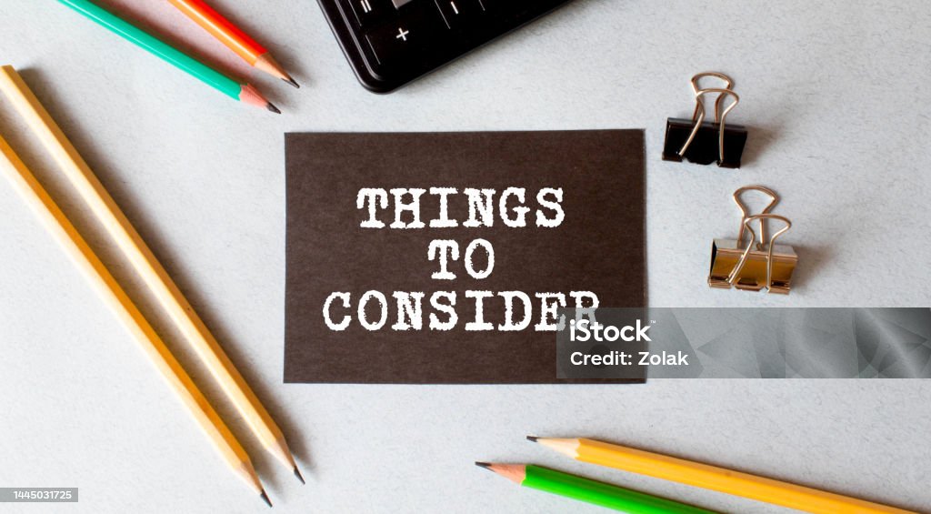 Selective focus of a pen, paper clips and notebook written with Things To Consider on wooden background. Selective focus of a pen, paper clips and notebook written with Things To Consider on wooden background Advice Stock Photo