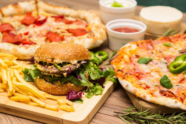 Pizza and hamburger on wooden background stock photo