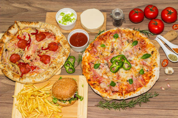 istock Pizza and hamburger on wooden background 1445035489