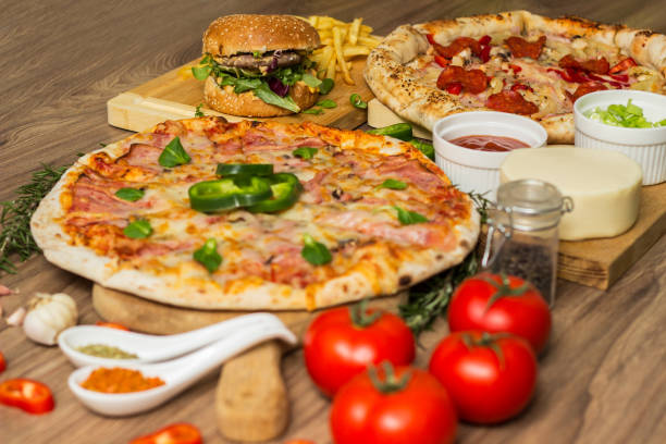 istock Pizza and hamburger on wooden background 1445035521