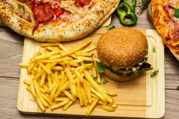 istock Pizza and hamburger on wooden background 1445035567