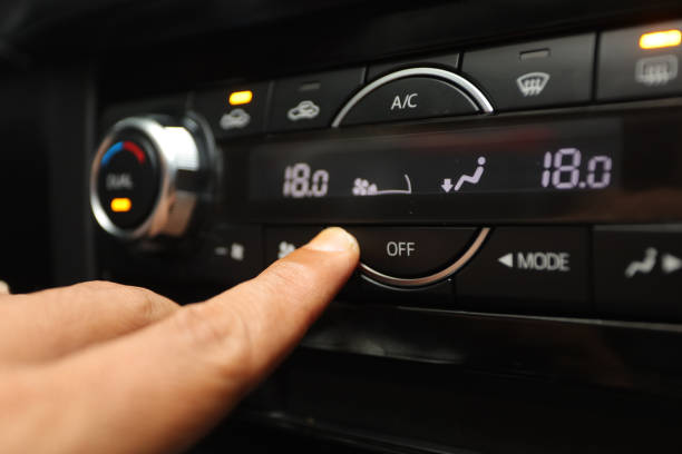 istock driver presses off button to turn off ac on luxury car dashboard 1445036789