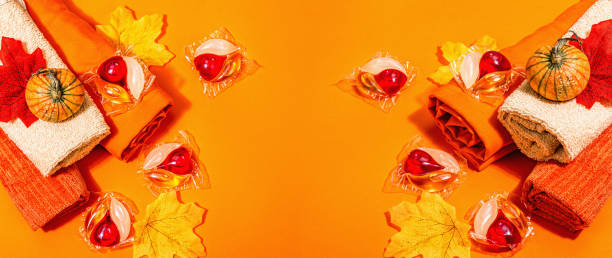 istock Machine washing concept. Capsules with detergent, soft towels and autumn decor. Laundry pods 1445038802