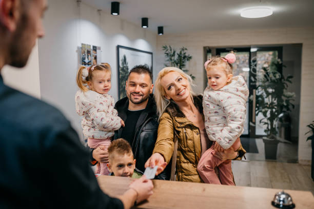 istock Family Checking In At Hotel Reception Desk 1445039505