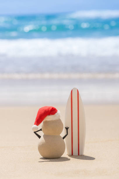 istock Sandy Christmas Snowman with a surf board 1445039687
