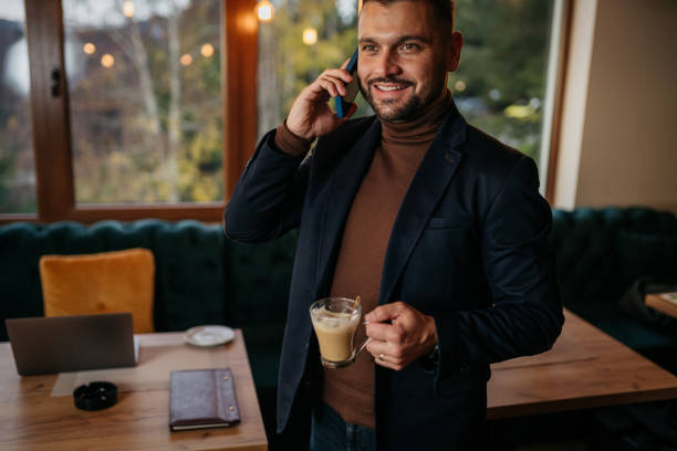 istock Handsome elegant businessman holding a cup of espresso 1445040304