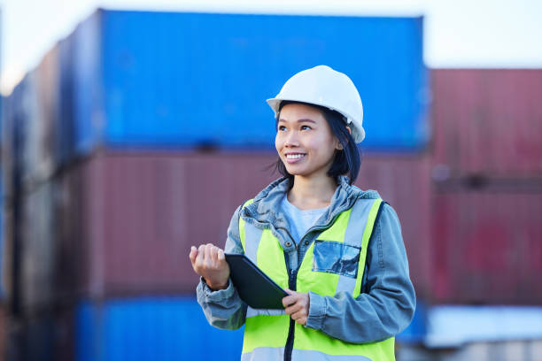 istock Cargo, logistics and shipping employee with tablet for digital checklist on container port for international transport. Asian woman industrial export manager working with inventory check with tech 1445043191
