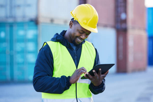 istock Logistics, tablet and black man doing container shipping at an industrial cargo, shipping and freight supply chain. Delivery manager or stock service worker working at distribution trade port outdoor 1445043204