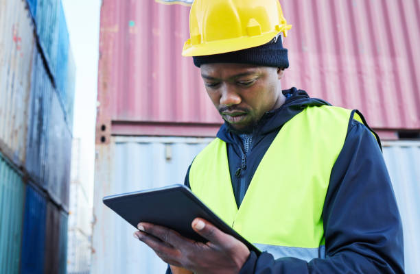 istock Digital tablet, logistics and black manager working on outdoor cargo freight site with shipping containers. African industrial man employee planning delivery, shipping and supply chain on mobile. 1445043474