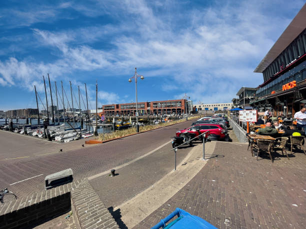 Den Haag, Netherlands - May 02 2022: people are sitting on the terrace of a restaurant in the scheveningen harbor
