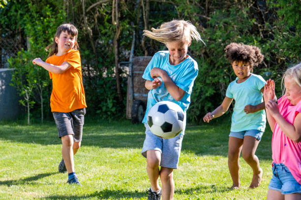 istock Active children running, playing soccer outdoors 1445044688