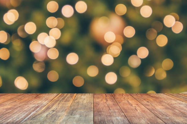 istock Empty wood table top with blur Christmas tree with bokeh light background 1445044796